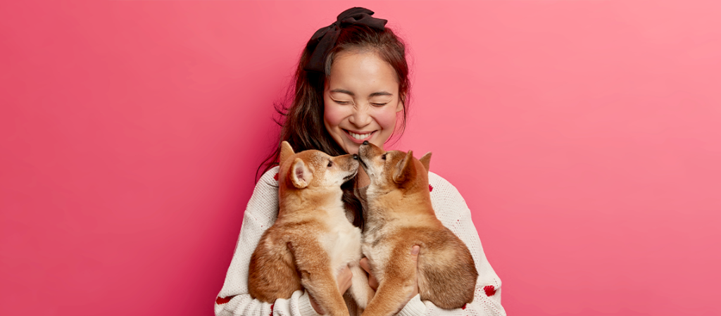 woman holding dogs