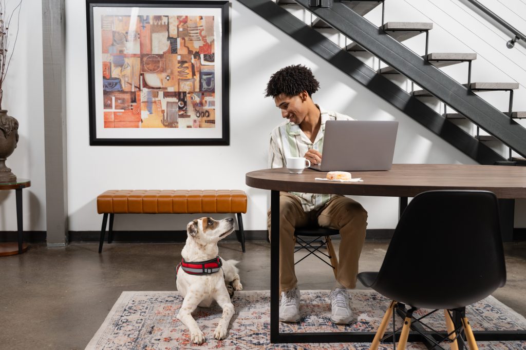 Dog owner smiling to its dog on the floor