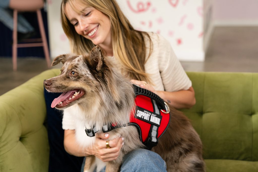 Woman embracing a support pet (dog)